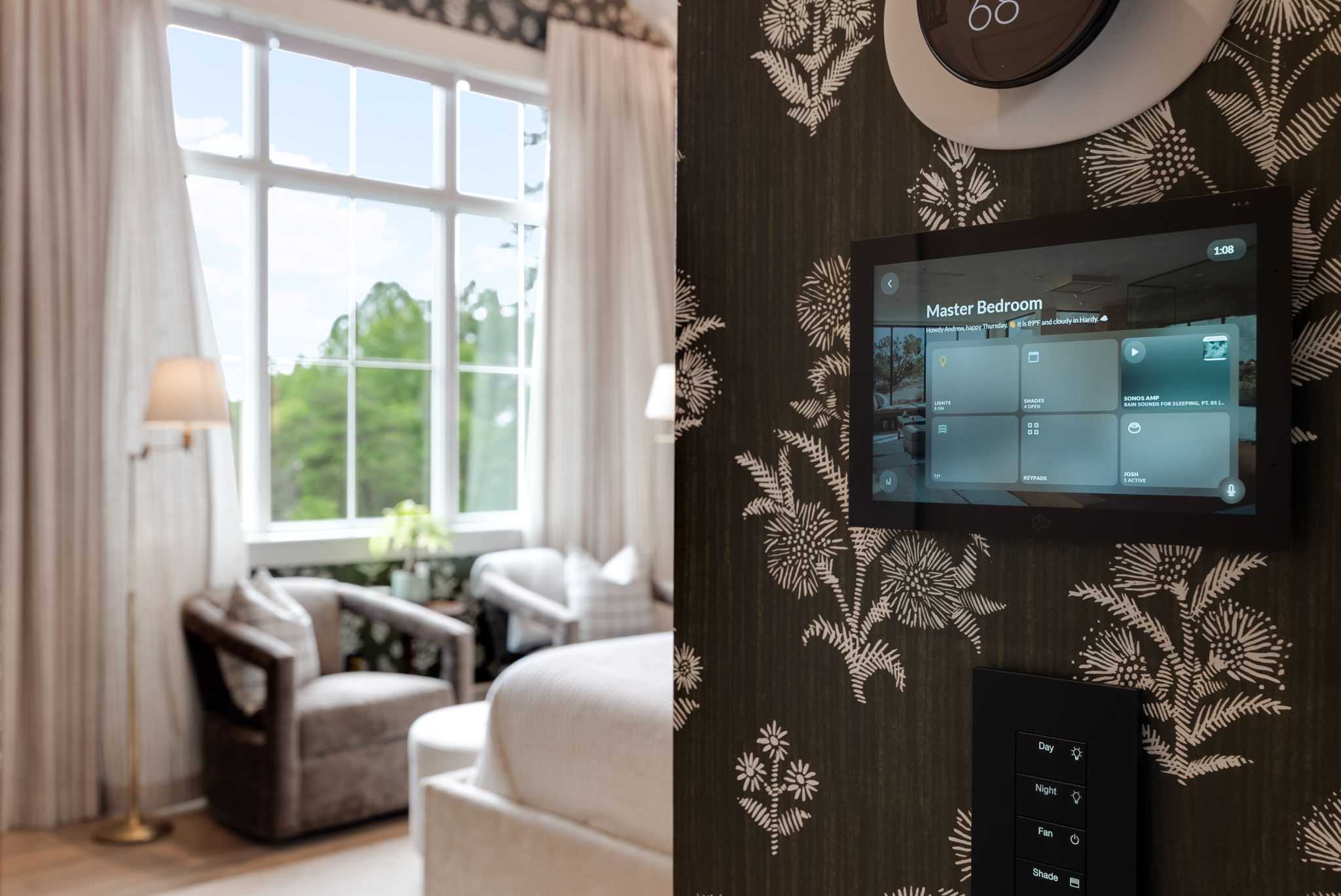 Wall-mounted smart home control panel in a bedroom