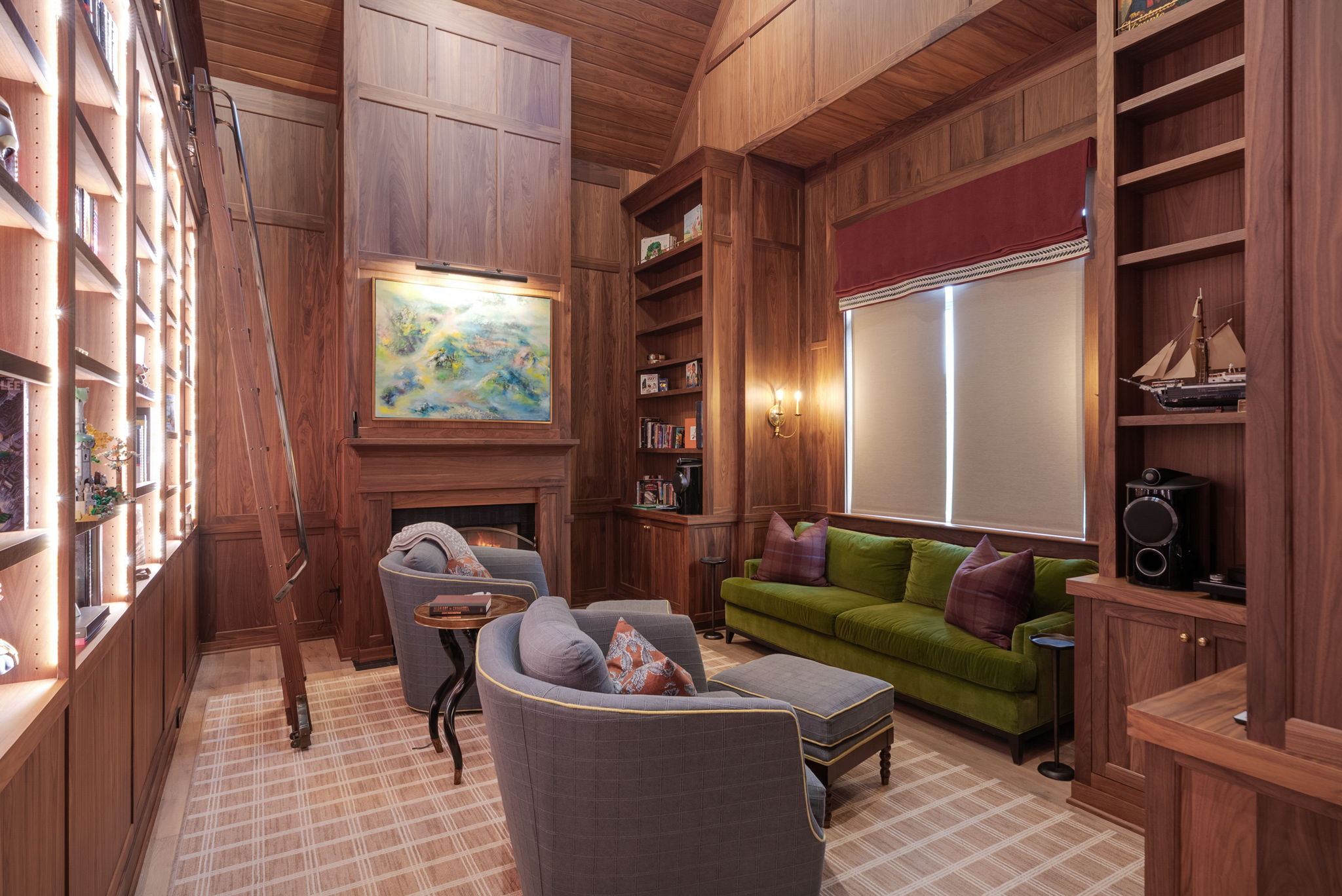 Wood-paneled library with seating and built-in shelves