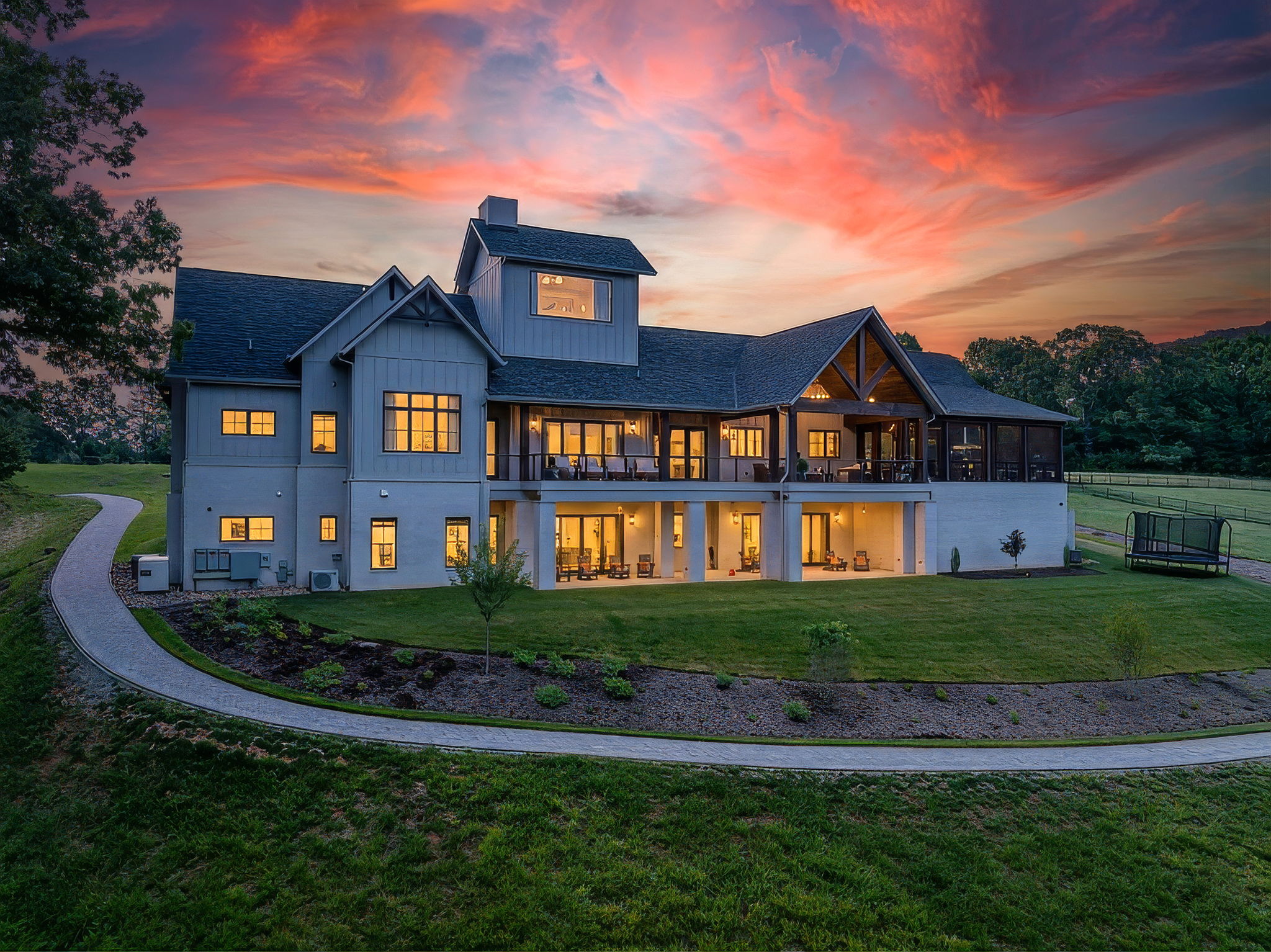 Rear exterior of the home and outdoor living areas at sunset
