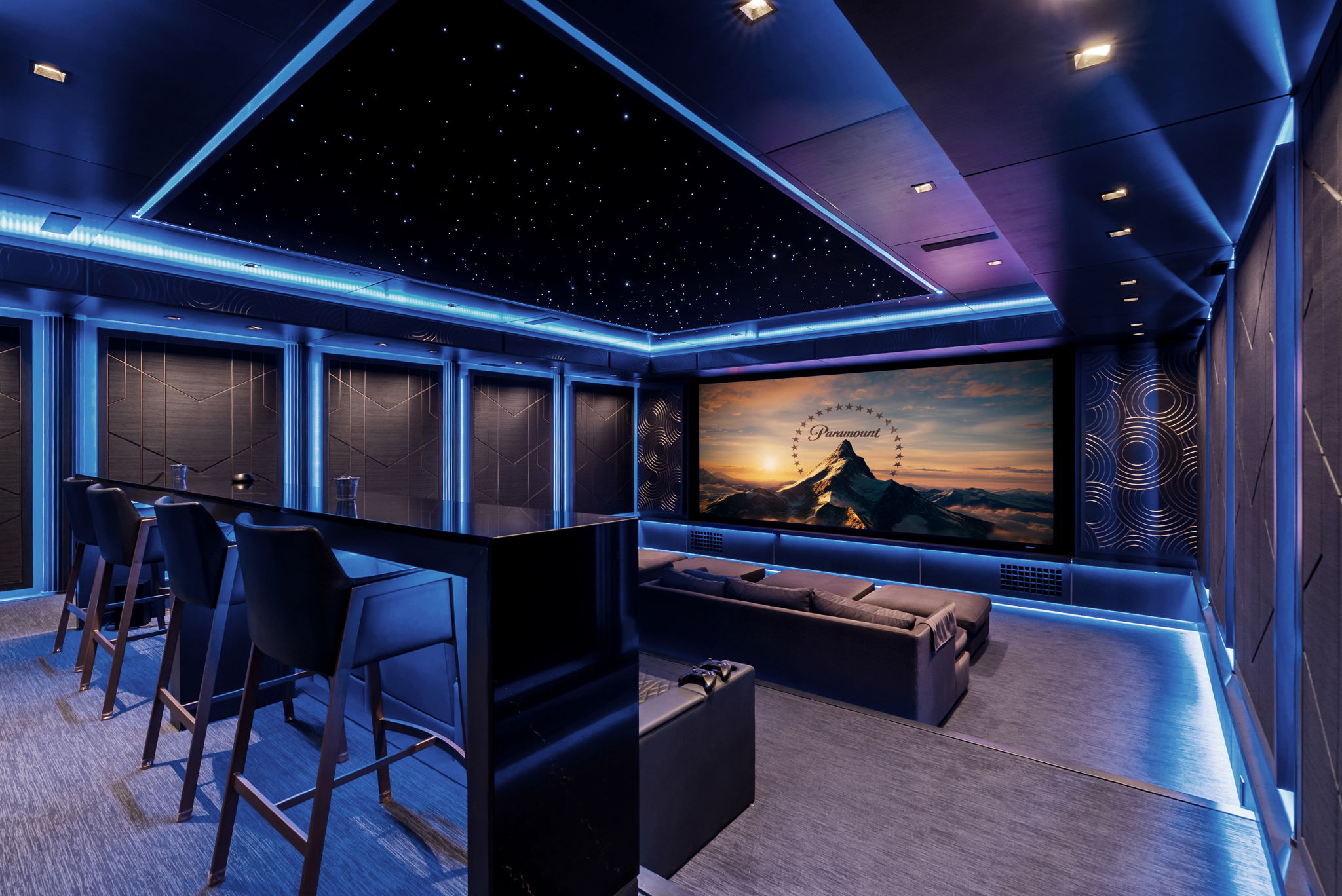 Private cinema with a star ceiling and blue accent lighting