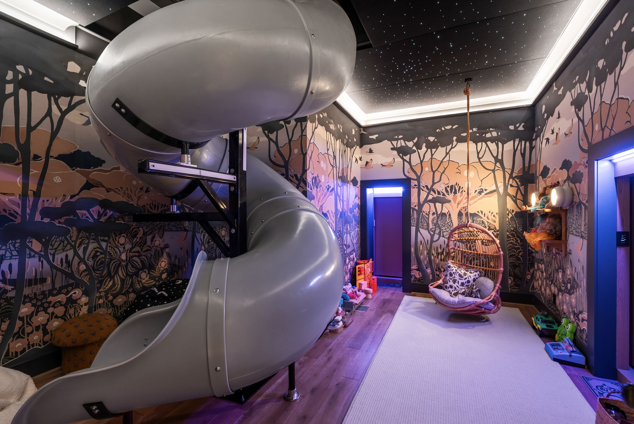 Slide and theatrical lighting inside the Narnia-inspired playroom