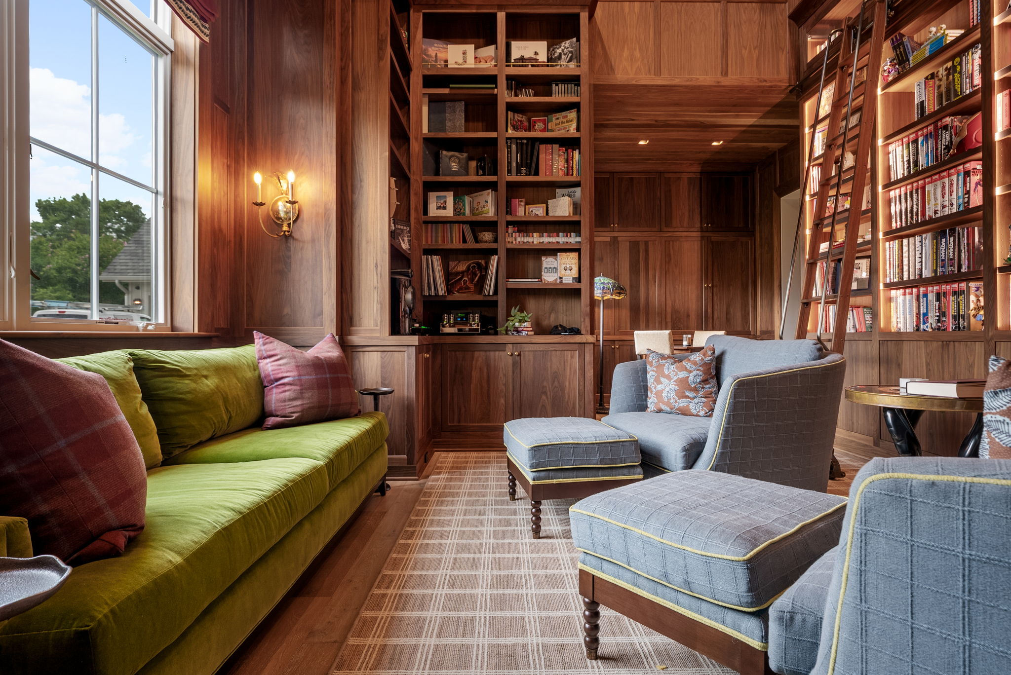 Library with a rolling ladder and floor-to-ceiling bookshelves