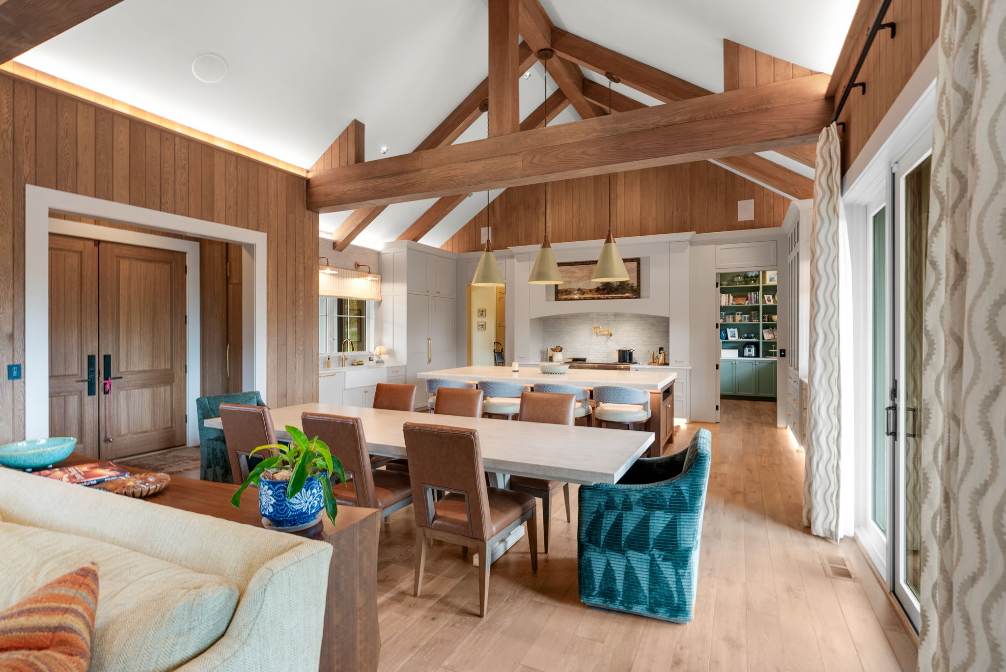 Open dining and living area with exposed wood beams
