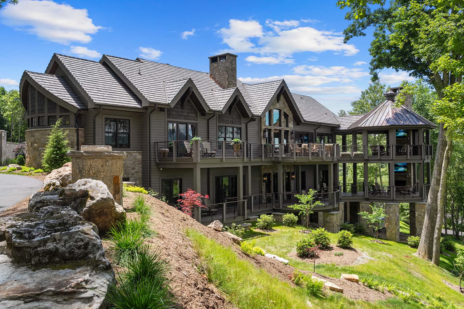 Large house with balconies and landscaping