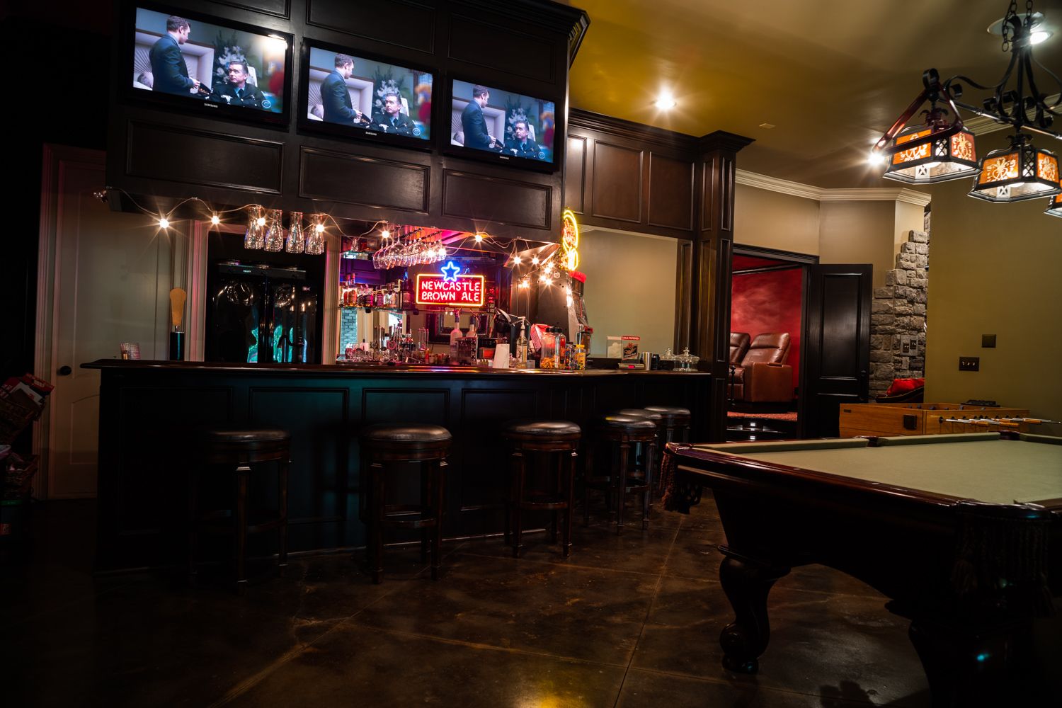 Bar with dark wood and pool table