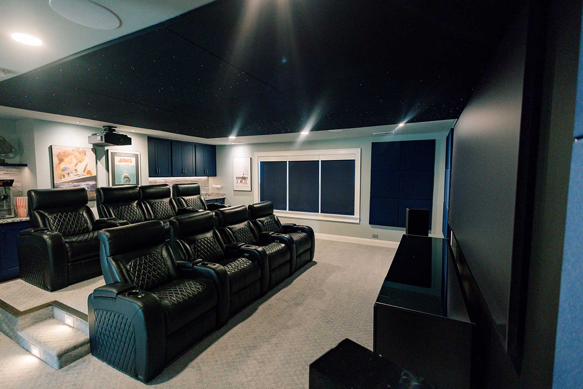 Home theatre with black recliner chairs